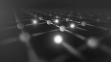 Farbliche Illustration mehrerer Elektronen in einer Anordnung mit Lichtpunkten auf dunklem Hintergrund.